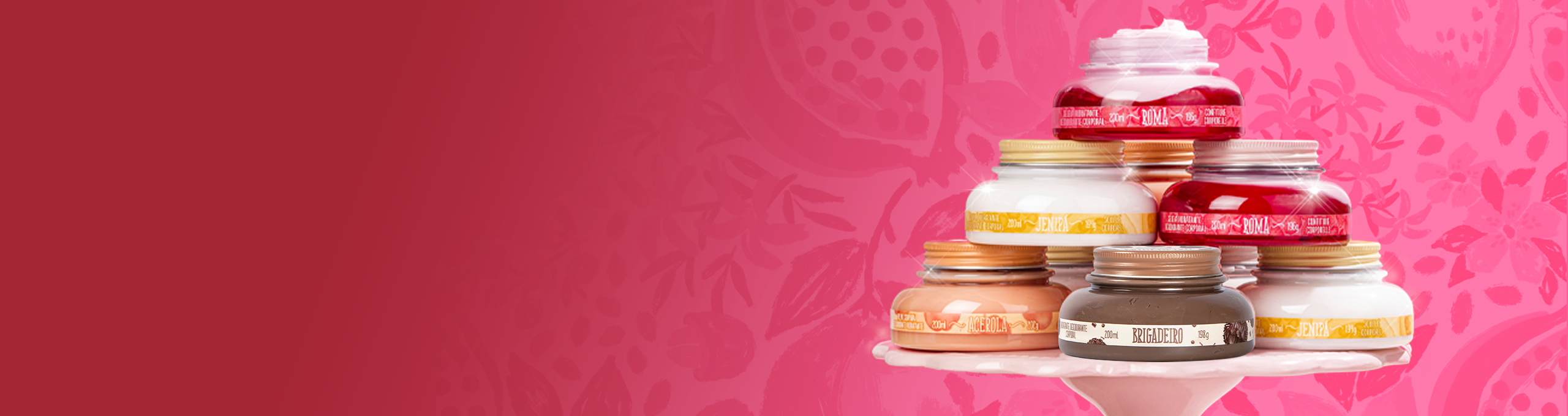 A imagem mostra uma pilha de potes de cremes em uma base branca, com diferentes fragrâncias, como "ROMÃ", "COCO" e "JENIPAPO", sobre um fundo rosa vibrante com desenhos de romã. Ao lado, há um texto em branco e rosa, escrito "Vem EMPREENDER COMIGO, mon amour!".